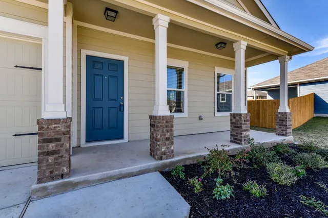 a view of front door of house with stairs