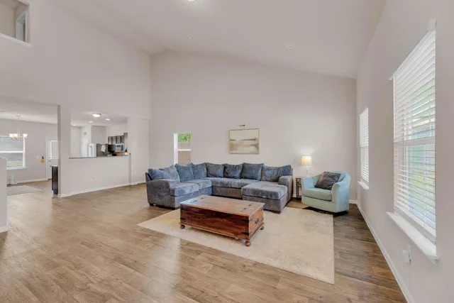 a living room with furniture and wooden floor