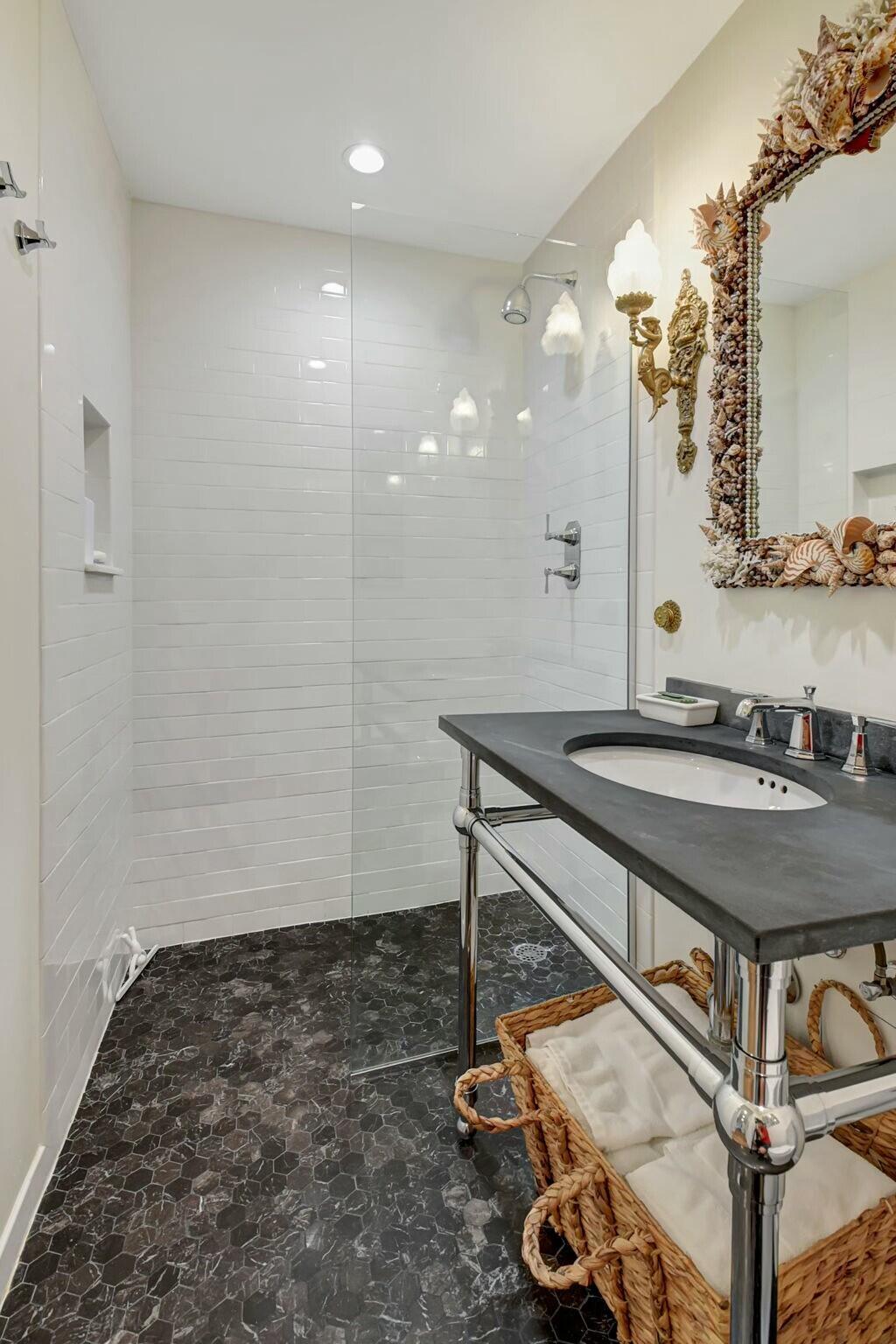 44 Cocoanut Row, Unit 104A Palm Beach, FL 33480 - Photo 17 of 26 a bathroom with a sink a mirror and shower