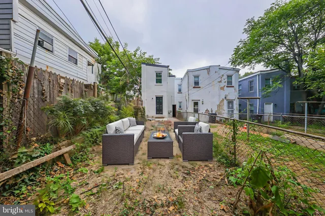 a view of a house with backyard and sitting area
