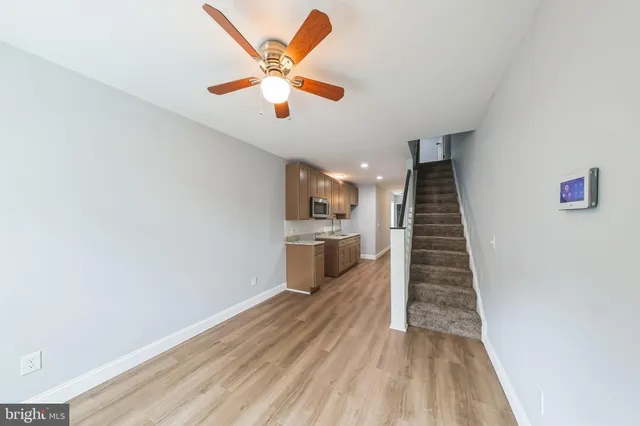 wooden floor in an empty room with a kitchen