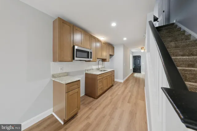 a kitchen with a sink a microwave a stove and refrigerator