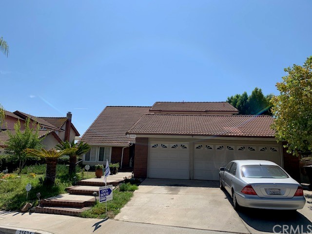 a front view of a house with car parked