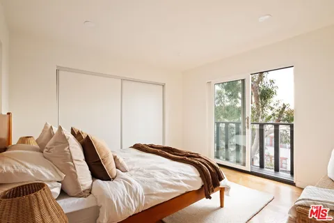 a bedroom with a bed and a large window