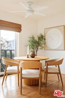 a living room with a table and a potted plant