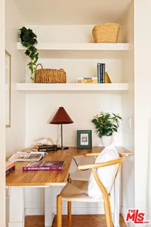 a picture of a room with a table and a potted plants