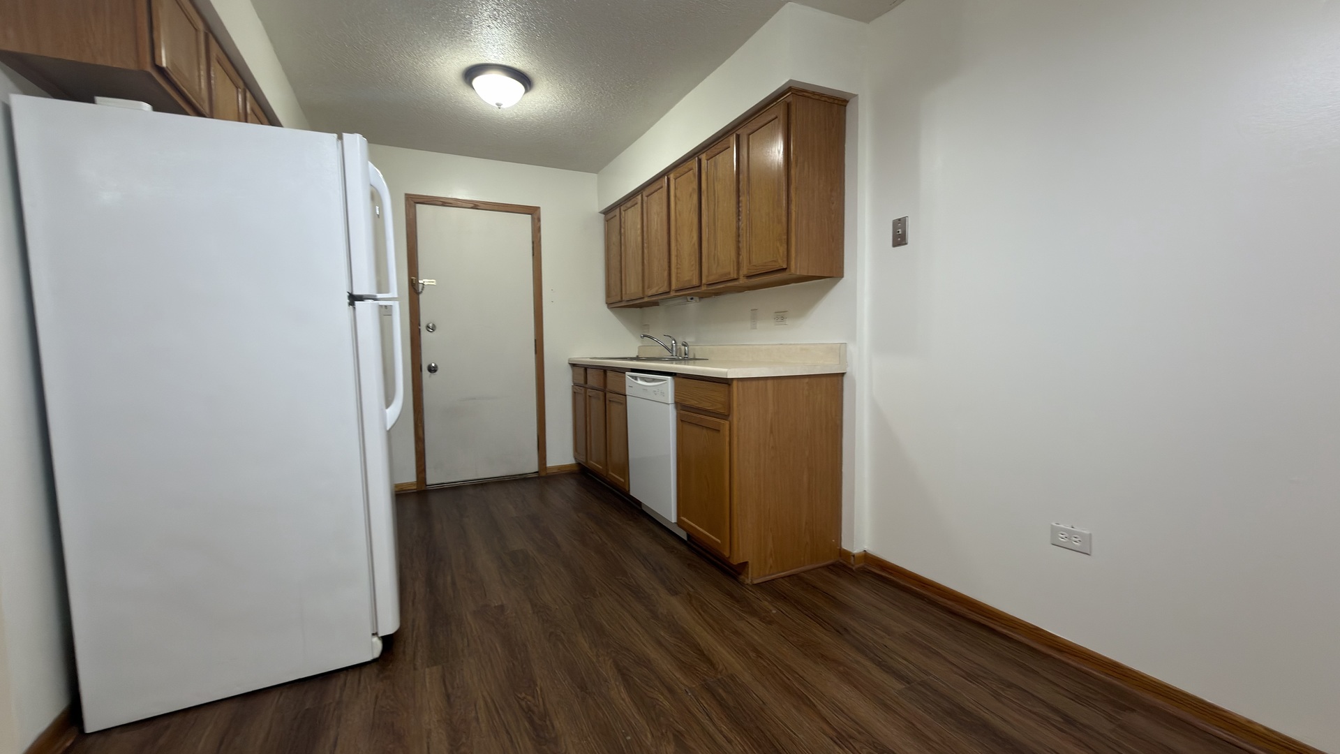7305 West 157th Street, Unit 3D Orland Park, IL 60462 - Photo 2 of 15 a view of a kitchen with wooden floor and electronic appliances