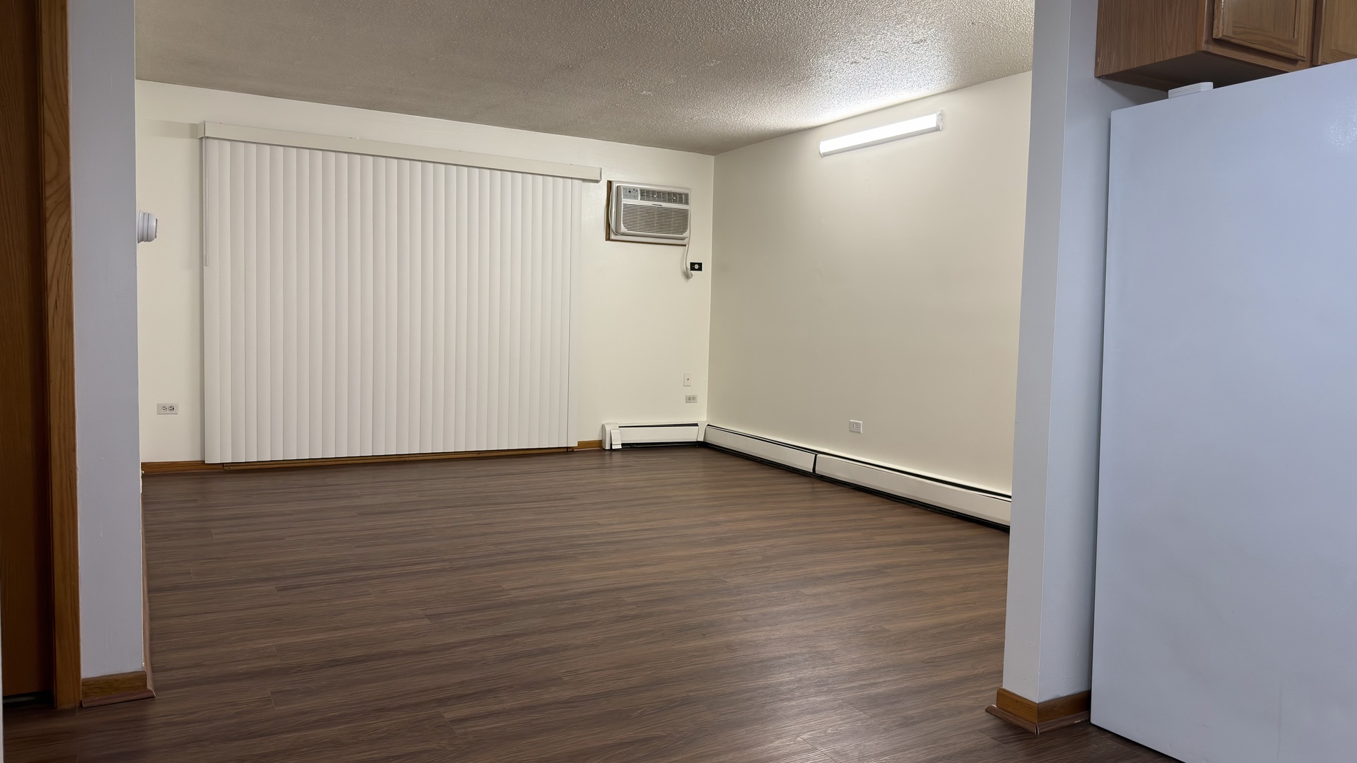 7305 West 157th Street, Unit 3D Orland Park, IL 60462 - Photo 8 of 15 an empty room with wooden floor and windows