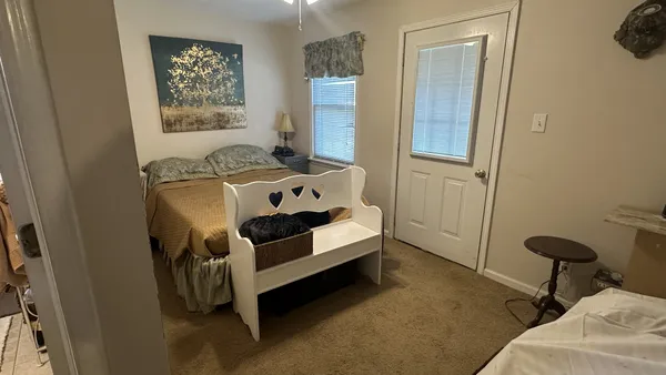 a bedroom with a bed and a window