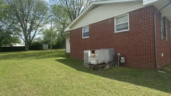a view of backyard with a garden and trees