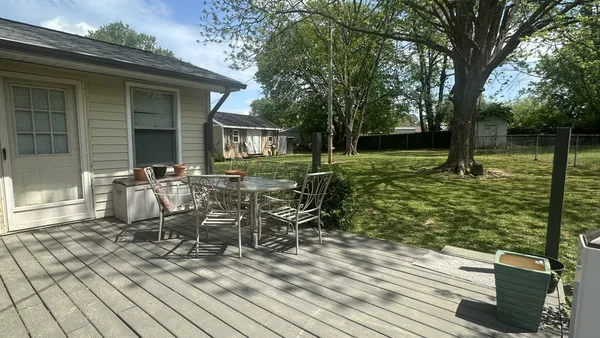 a view of a house with backyard sitting area and garden