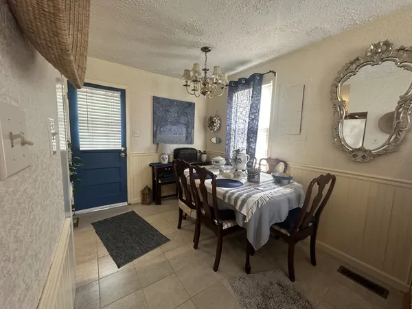 a view of a dining room with furniture and window