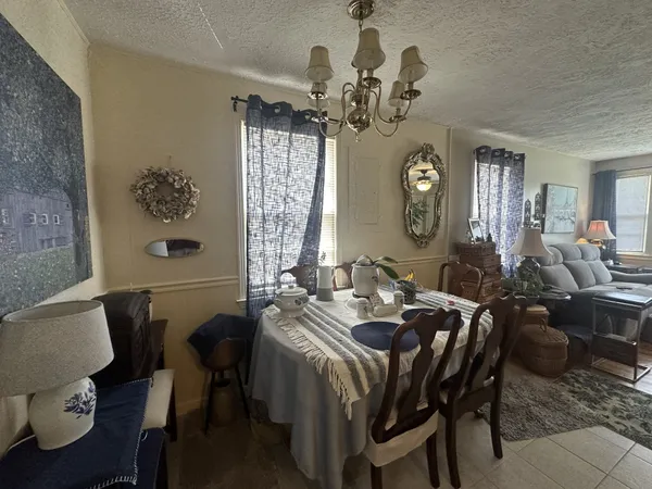 a view of a dining room with furniture and chandelier