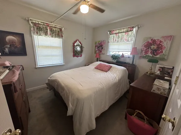 a bedroom with a bed next to a window