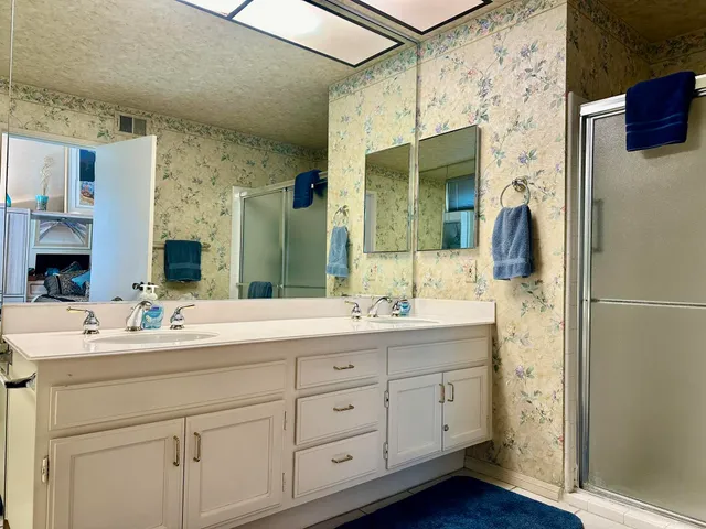 a bathroom with a double vanity sink and mirror