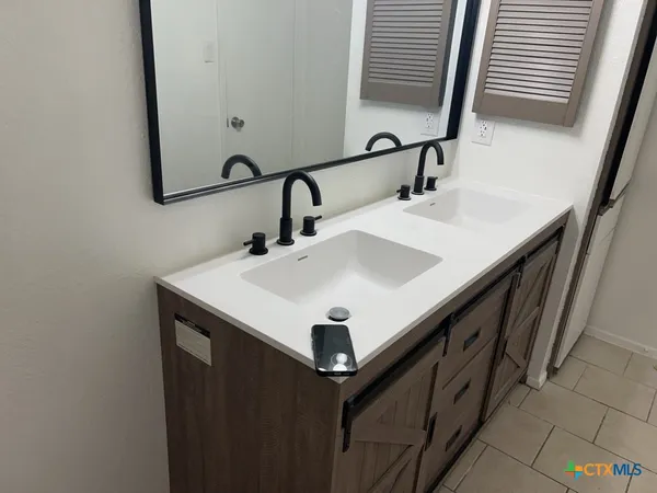 a bathroom with a sink and a mirror