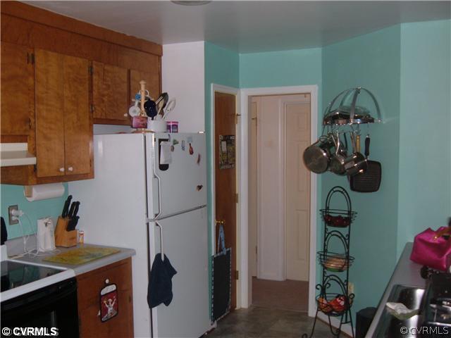 3112 South Ridge Drive Midlothian, VA 23112 - Photo 4 of 7 a kitchen with a refrigerator and a wooden cabinets