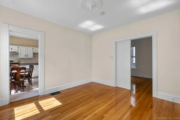 a view of empty room with wooden floor