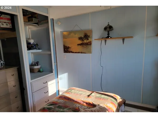 a bedroom with a bed window and a potted plant