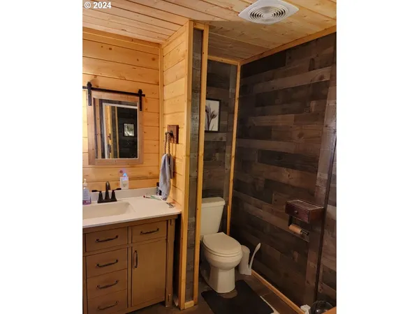 a bathroom with a glass shower door
