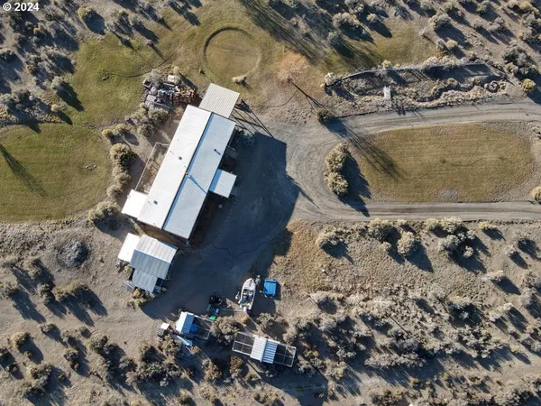 an aerial view of a house with a swimming pool