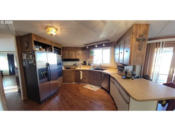 a view of a dining room with furniture and wooden floor