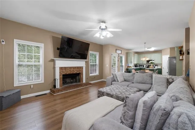 a living room with furniture and wooden floor