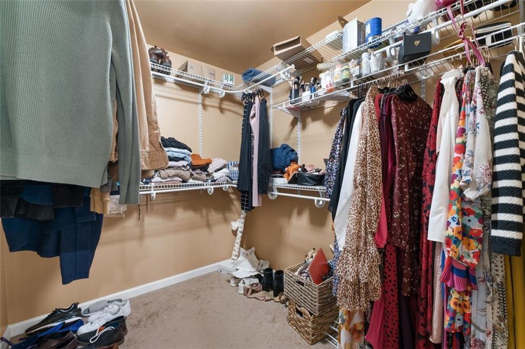 19 Creekside View Hiram, GA 30141 - Photo 24 of 46 a view of walk in closet with clothes and shoes