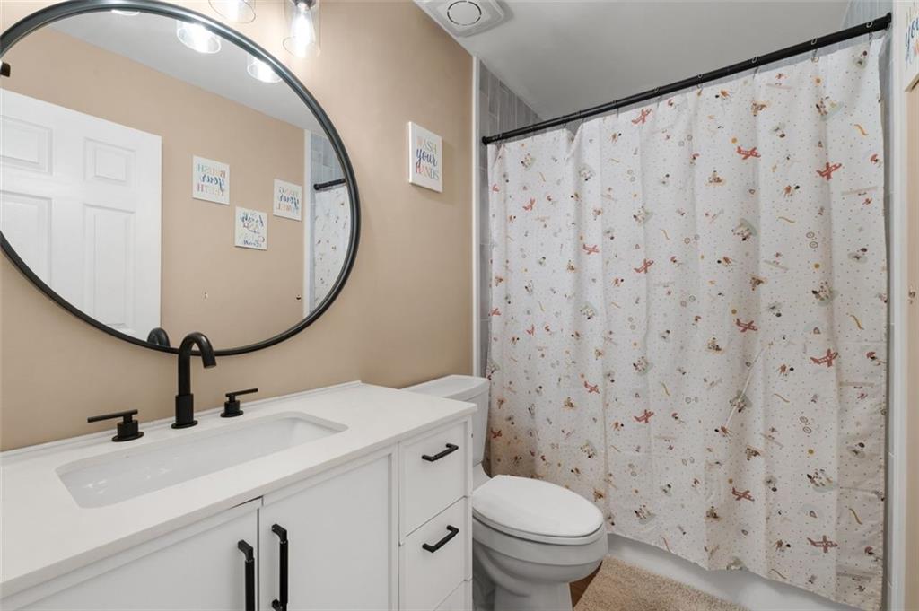 19 Creekside View Hiram, GA 30141 - Photo 26 of 46 a bathroom with a sink toilet and mirror