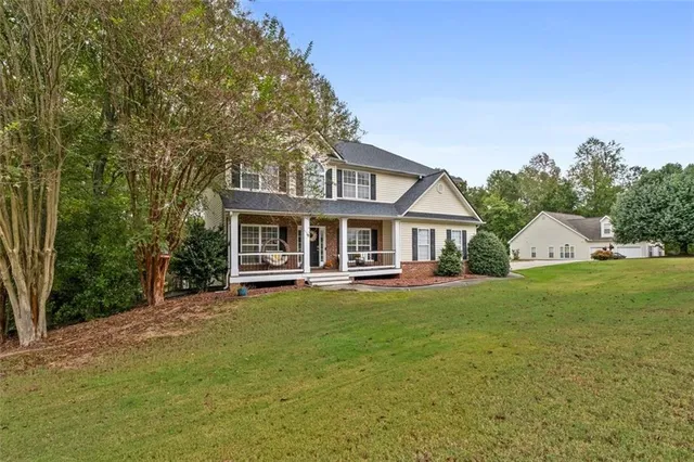 a front view of a house with swimming pool having outdoor seating