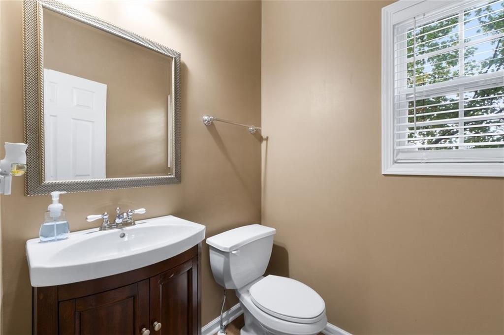 19 Creekside View Hiram, GA 30141 - Photo 10 of 46 a bathroom with a sink a toilet a mirror and a window