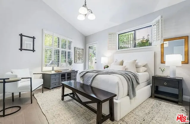 a bedroom with a bed a table and chair