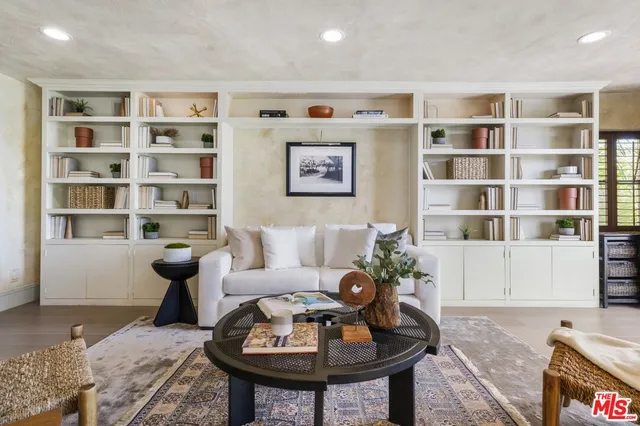 a living room with furniture and a book shelf