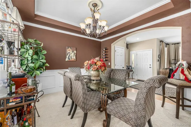 a view of a dining room with furniture and a chandelier