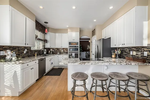 a kitchen with stainless steel appliances kitchen island granite countertop a sink and cabinets