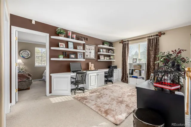 a living room with furniture and a book shelf
