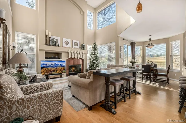 a living room with fireplace furniture and a large window