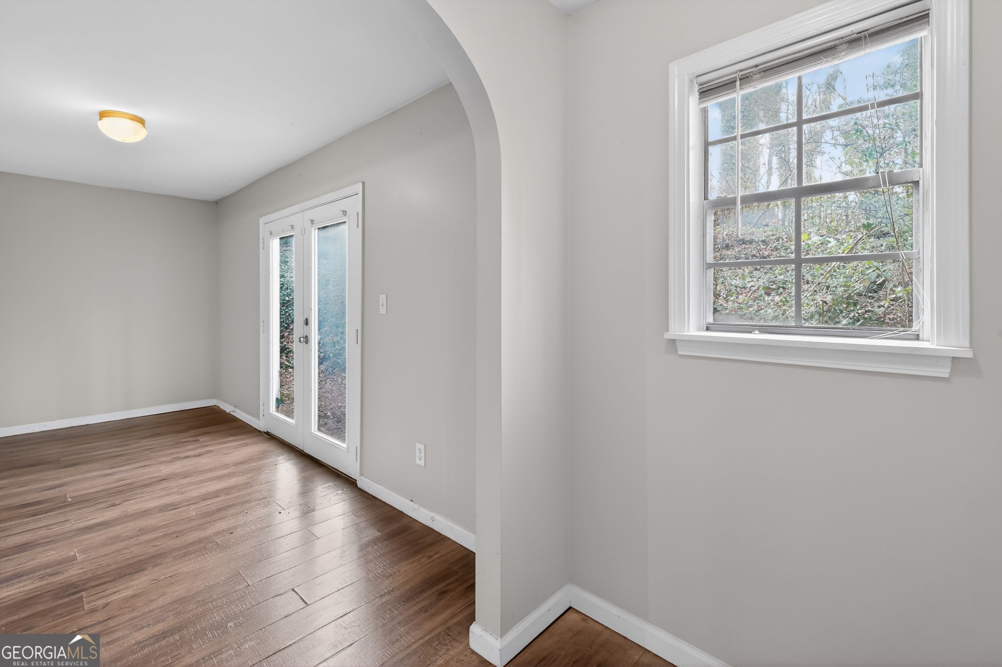 4629 ROUSAY Court Stone Mountain, GA 30083 - Photo 11 of 33 an empty room with wooden floor and windows