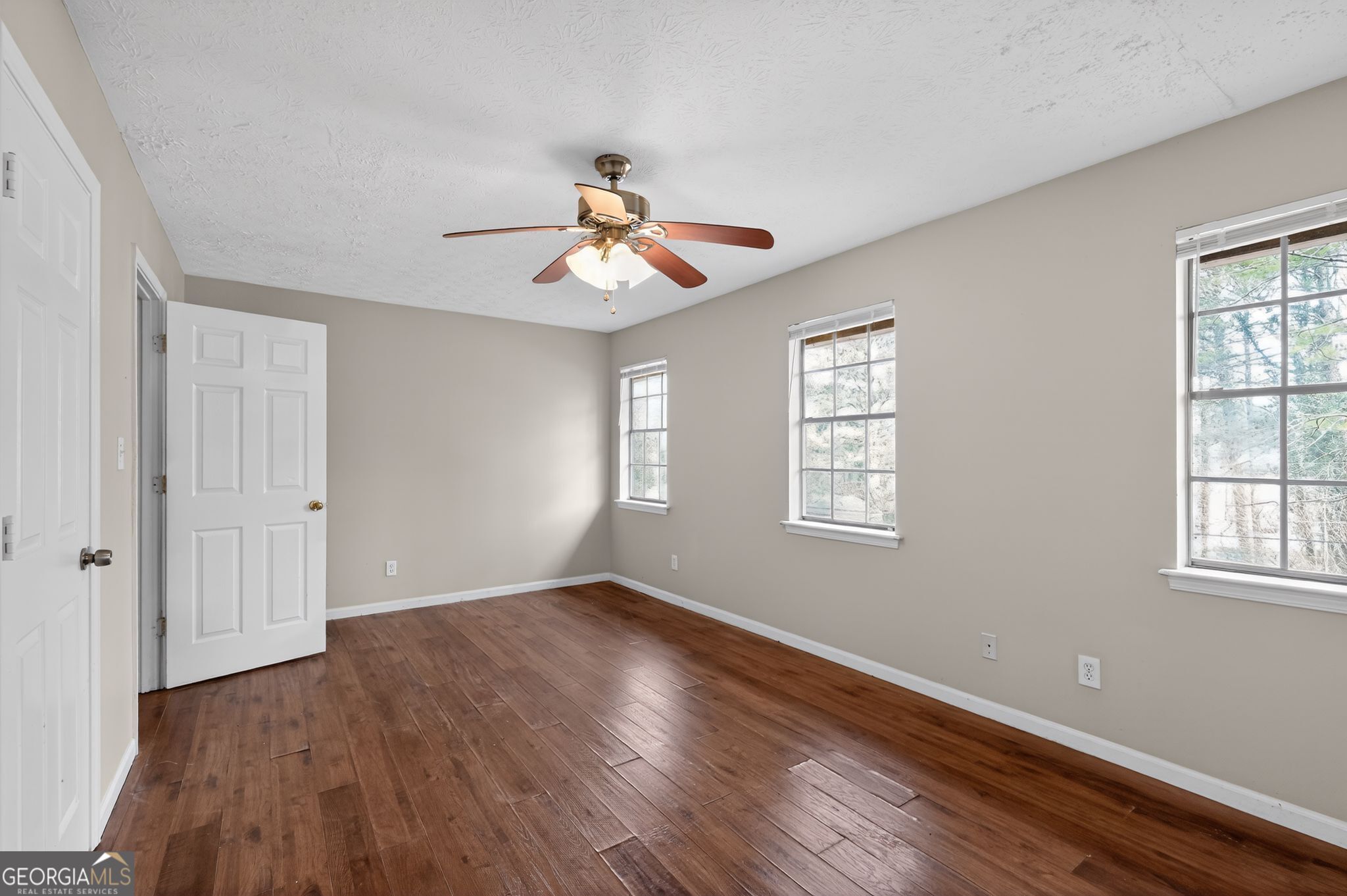 4629 ROUSAY Court Stone Mountain, GA 30083 - Photo 13 of 33 a view of an empty room with wooden floor and a window