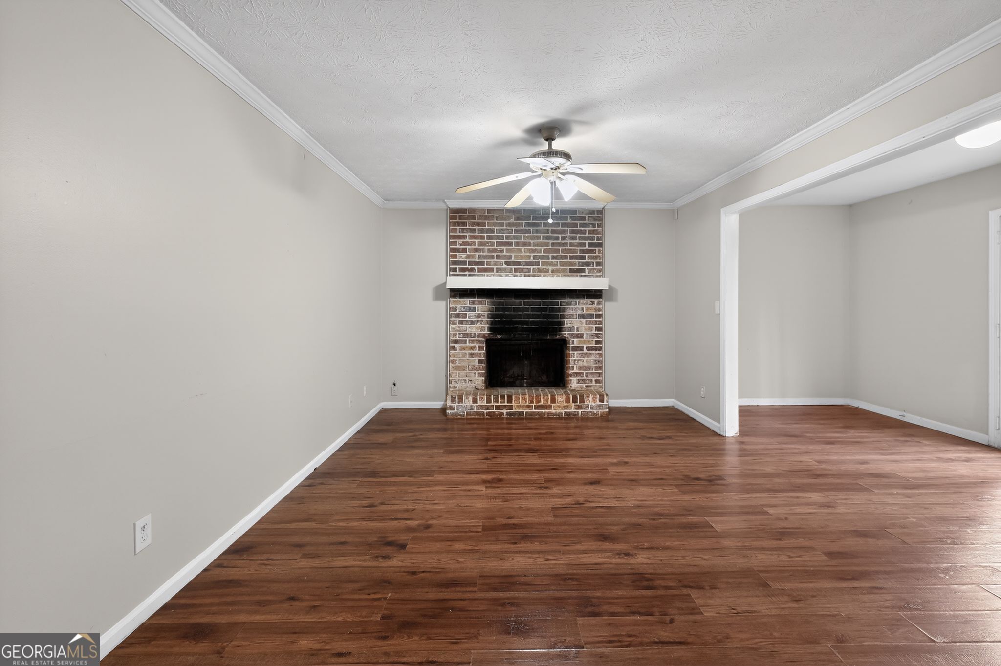 4629 ROUSAY Court Stone Mountain, GA 30083 - Photo 14 of 33 a view of an empty room with wooden floor fireplace and a window