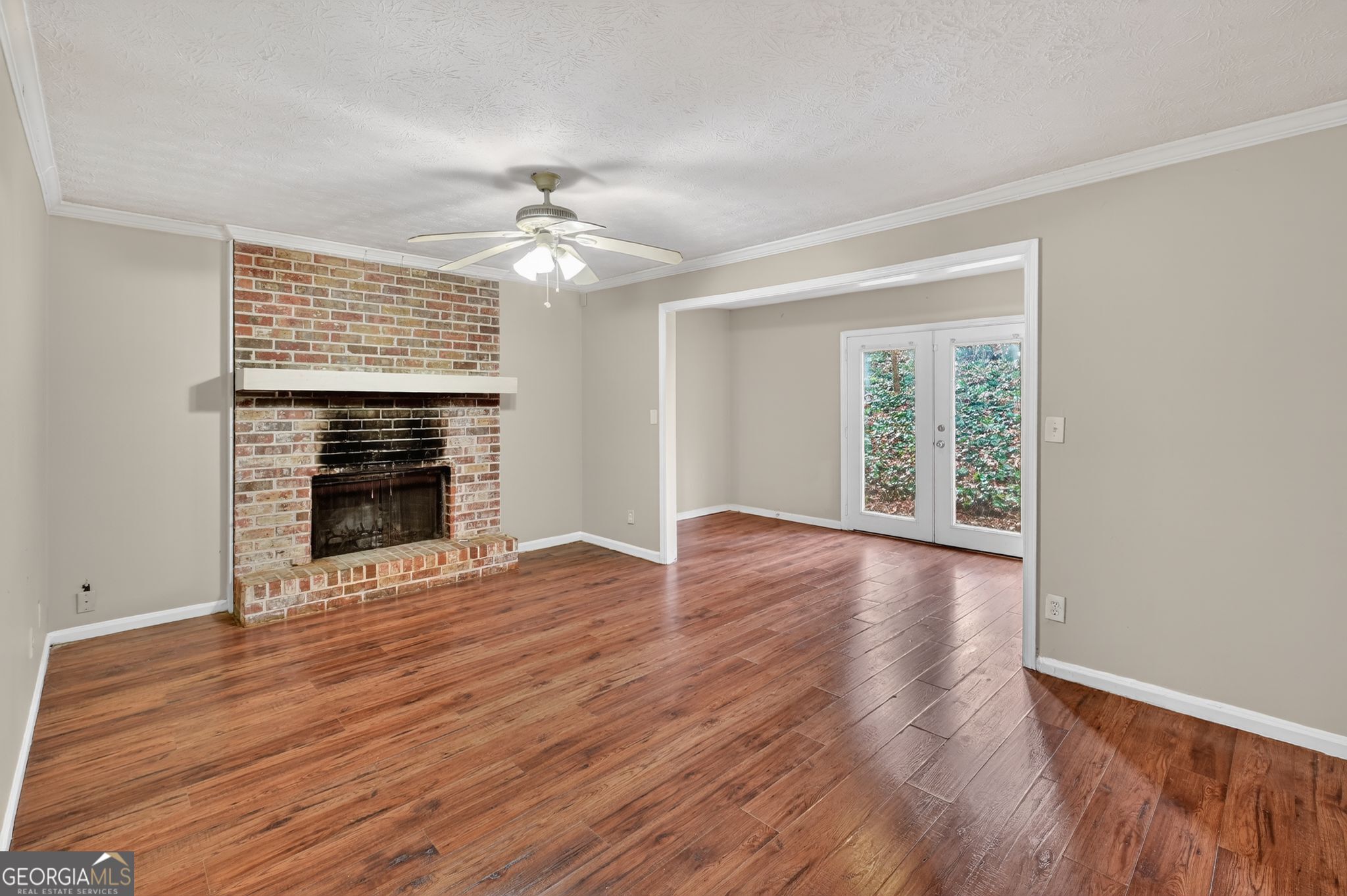 4629 ROUSAY Court Stone Mountain, GA 30083 - Photo 15 of 33 a view of an empty room with wooden floor fireplace and a window