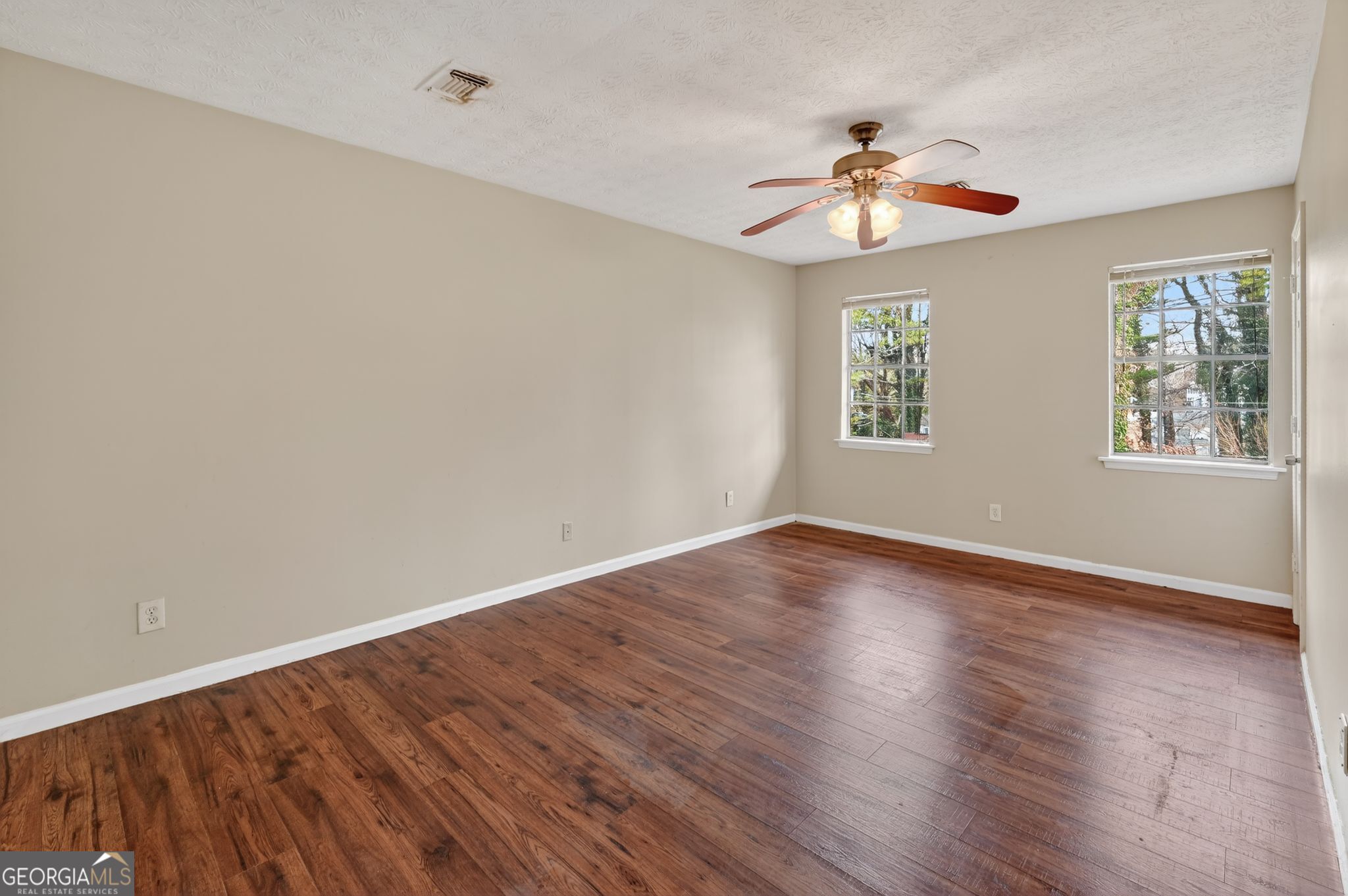 4629 ROUSAY Court Stone Mountain, GA 30083 - Photo 16 of 33 a view of an empty room with wooden floor and a window