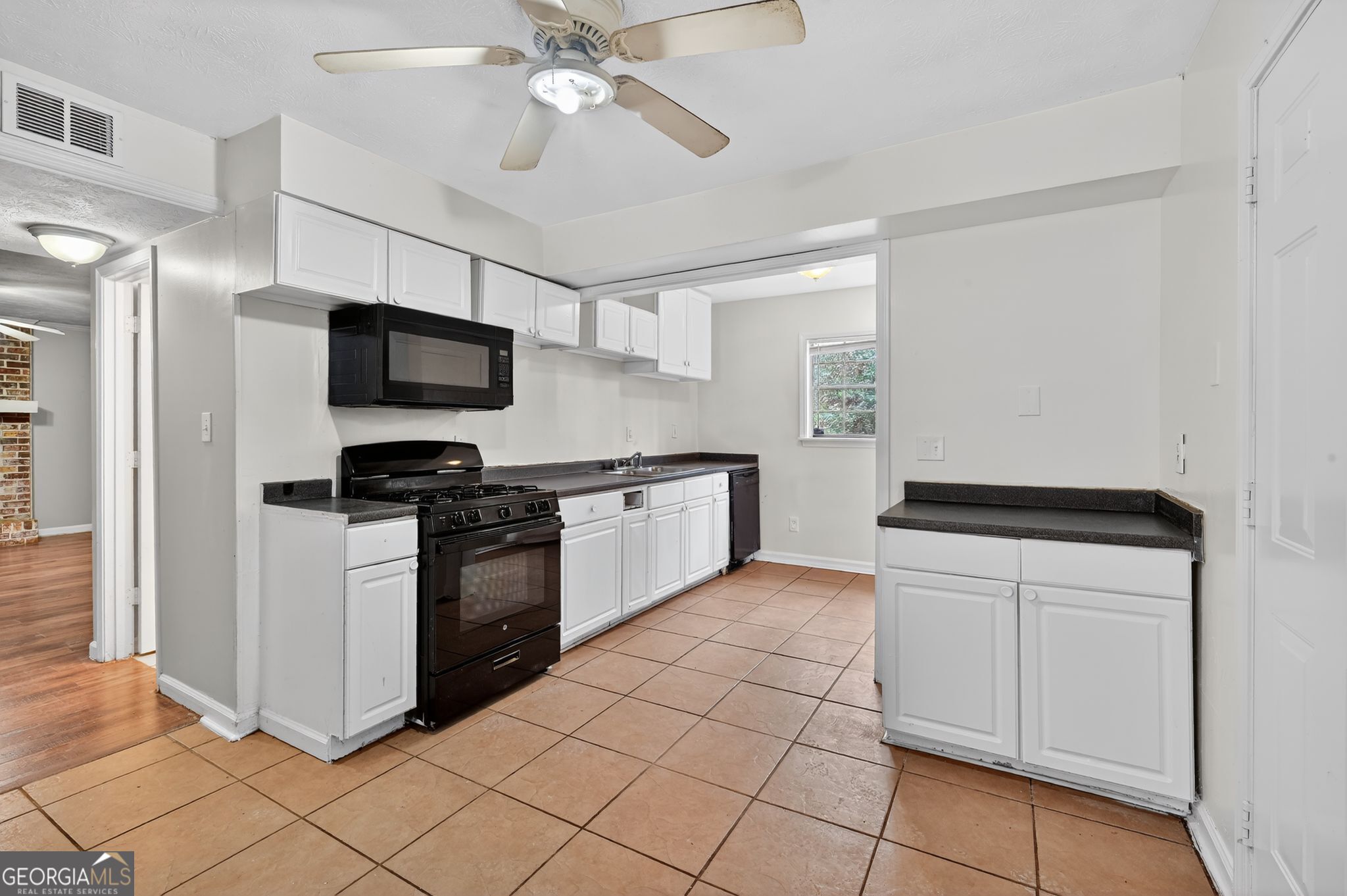 4629 ROUSAY Court Stone Mountain, GA 30083 - Photo 18 of 33 a kitchen with a stove a sink and a refrigerator