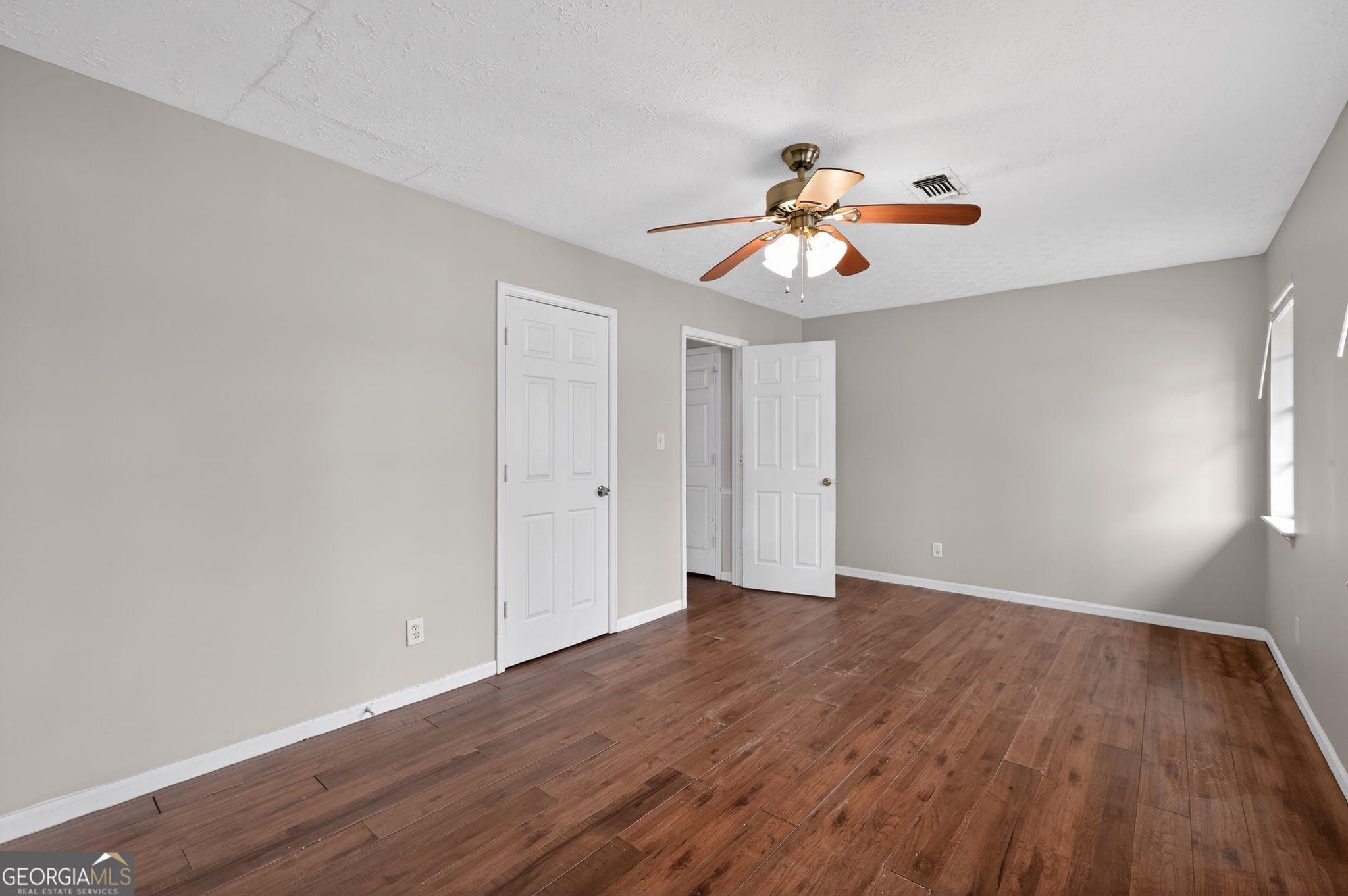 4629 ROUSAY Court Stone Mountain, GA 30083 - Photo 20 of 33 a view of an empty room with window and wooden floor