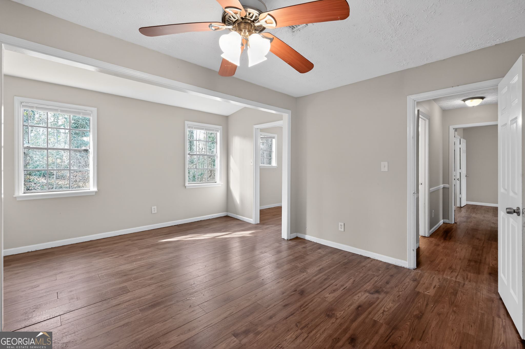 4629 ROUSAY Court Stone Mountain, GA 30083 - Photo 21 of 33 a view of an empty room with wooden floor and a window