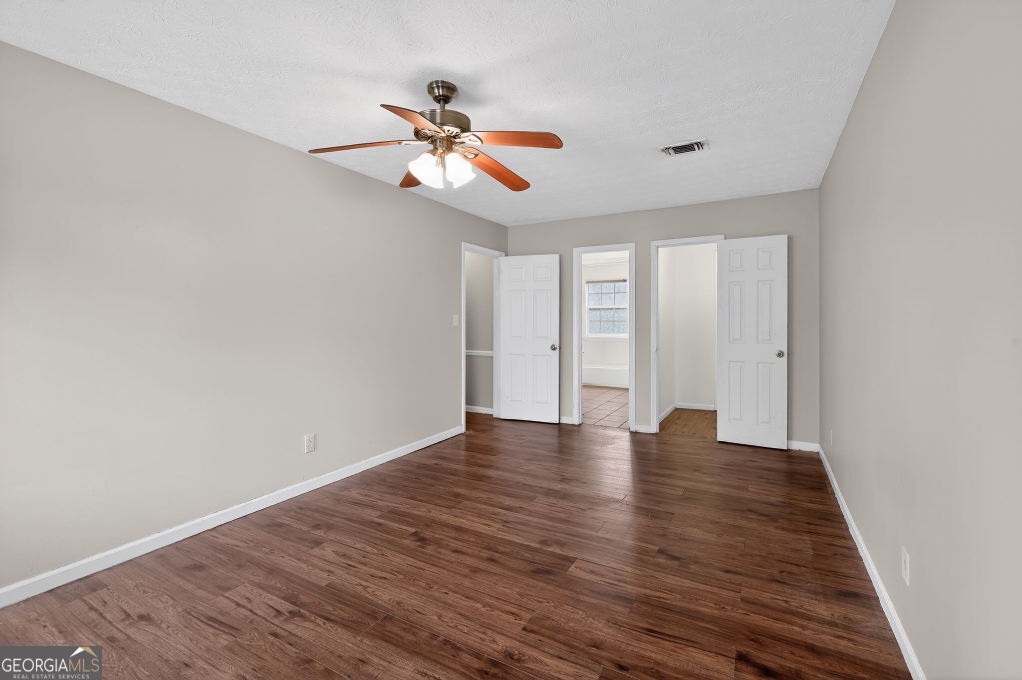 4629 ROUSAY Court Stone Mountain, GA 30083 - Photo 22 of 33 a view of an empty room with window and wooden floor
