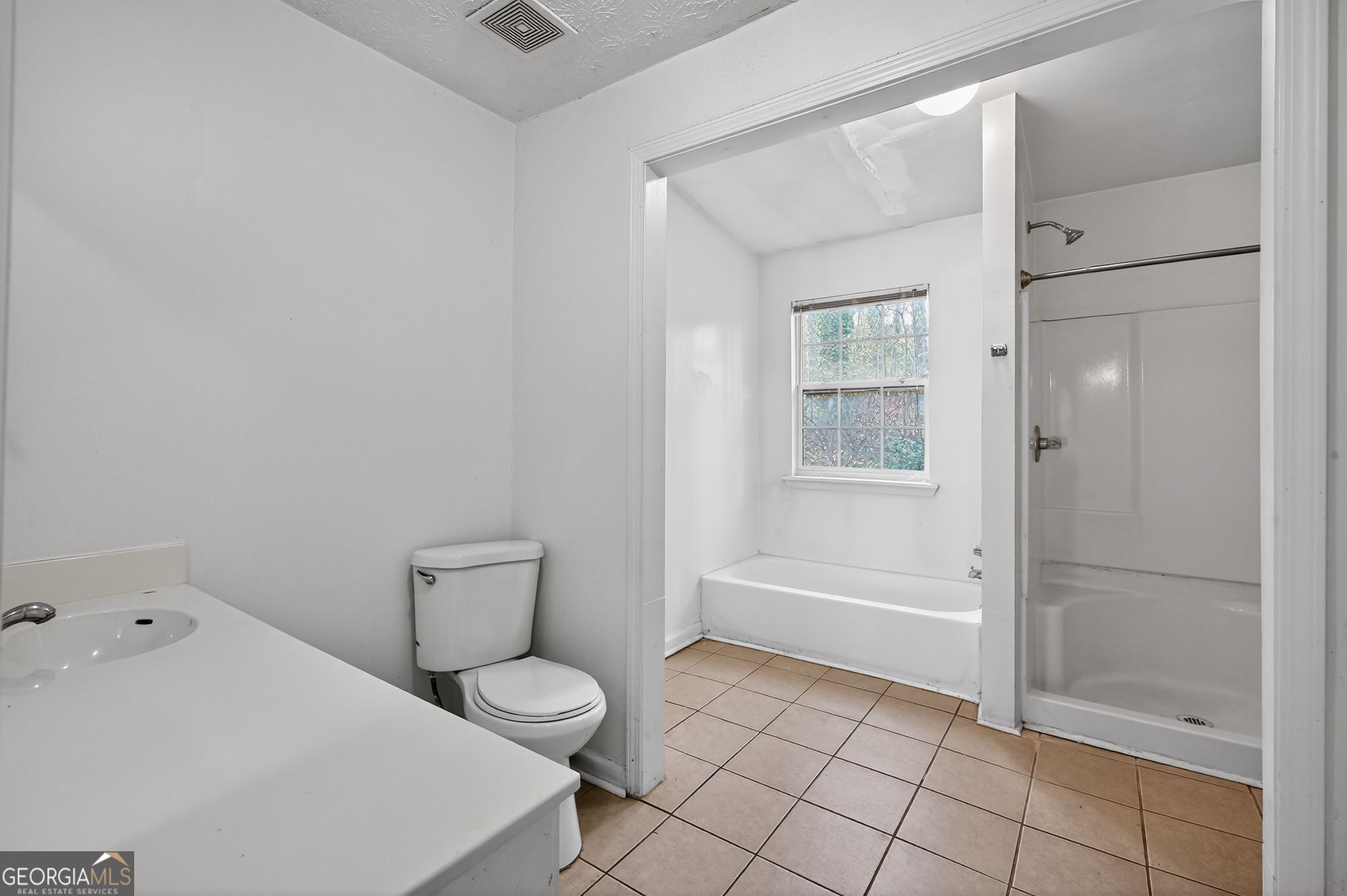 4629 ROUSAY Court Stone Mountain, GA 30083 - Photo 24 of 33 a bathroom with a toilet and a shower