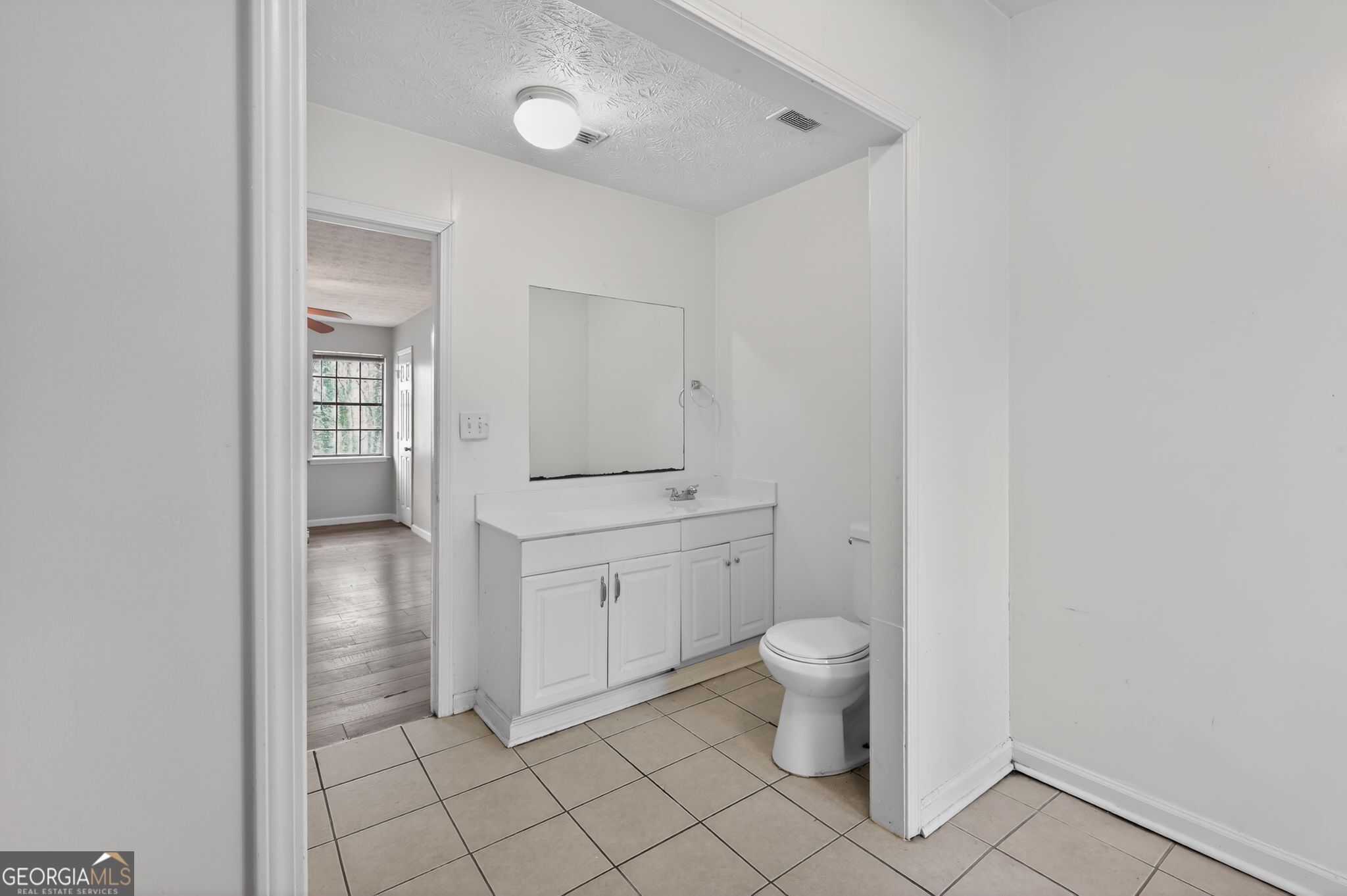 4629 ROUSAY Court Stone Mountain, GA 30083 - Photo 26 of 33 a bathroom with a toilet sink and mirror