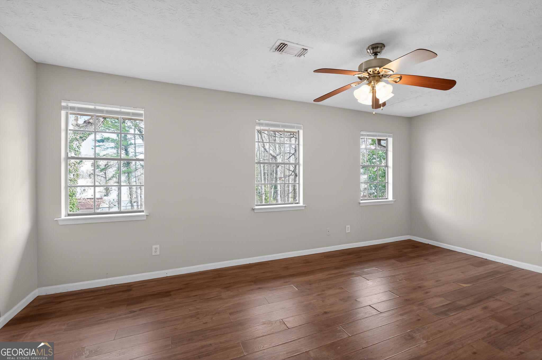 4629 ROUSAY Court Stone Mountain, GA 30083 - Photo 4 of 33 a view of an empty room with wooden floor and a window