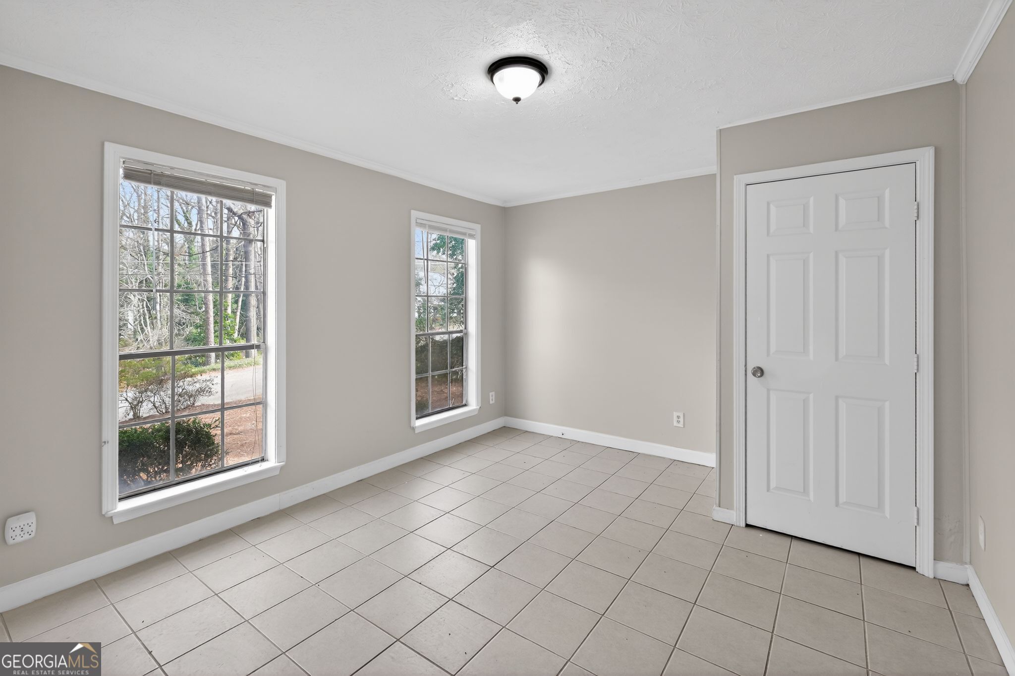 4629 ROUSAY Court Stone Mountain, GA 30083 - Photo 6 of 33 a view of an empty room with window and chandelier fan